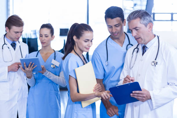 istock Medical team discussing paperwork on clipboard 675641260
