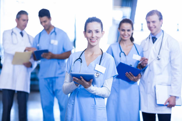 istock Female doctor using tablet and smiling at camera 675641324