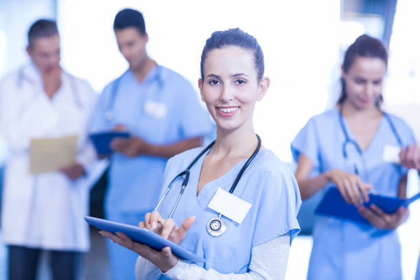 istock Female doctor using tablet and smiling at camera 675641348