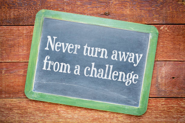 istock Never turn away from a challenge blackboard sign 675641544