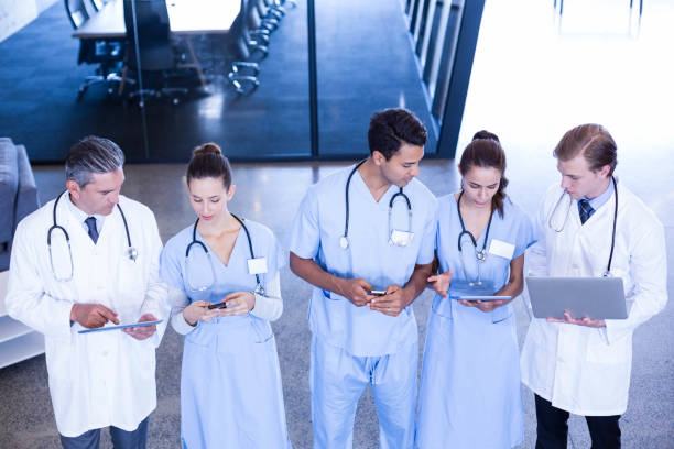 istock Medical team using laptop, mobile and digital tablet 675641960