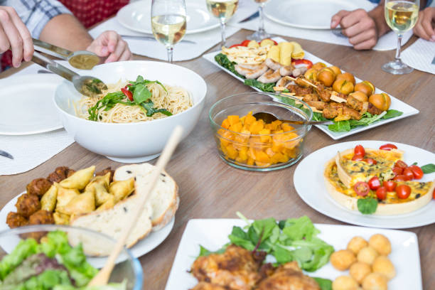 istock Cropped image of people with food served on table 675642432