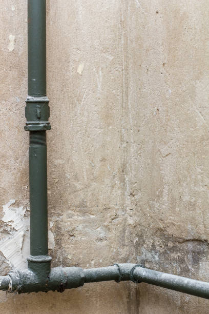 istock On the wall in a corner is an old heating pipes, without a radiator. 675644420