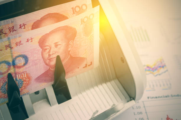 Banknotes of China with a portrait of Mao Zedong. Banknotes of China with a portrait of Mao Zedong on an automatic bill counter. Used for China economy related i.e. industrial PMI, GDP growth, inflation, interest, balance of trade, debt to GDP, etc prc stock pictures, royalty-free photos & images