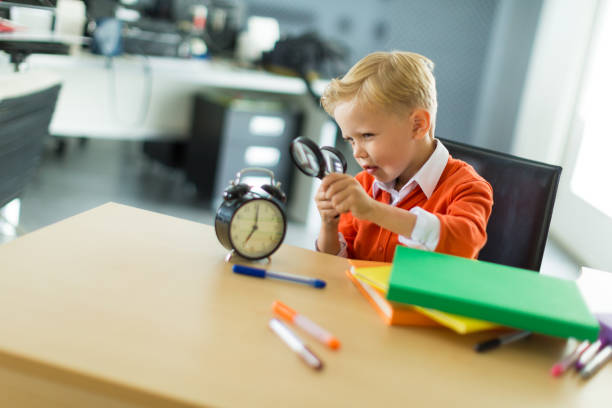 istock Young boy sit at the desk in the office 675646394