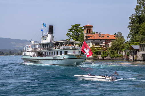 Cruiser ship with red swiss flag. Geneva lake, Switzerland