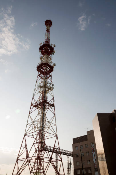 istock Telecommunications tower and satellite dish telecom network on evening sky 675653864