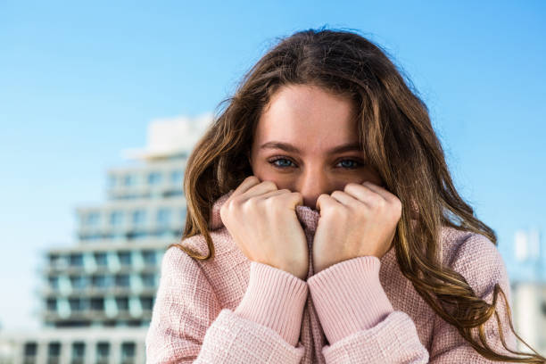 istock Young girl hiding her mouth 675664972