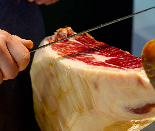 Man cutting serrano ham