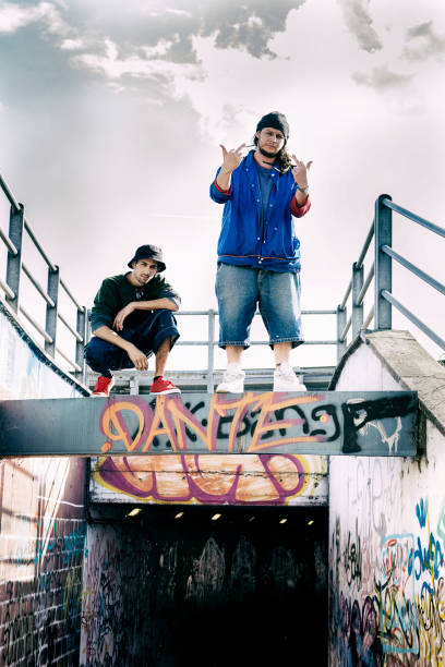 istock Two rap singers on a concrete beam with graffiti in the background 675676806
