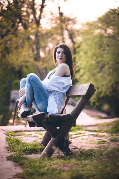 Beautiful young woman sitting on a bench