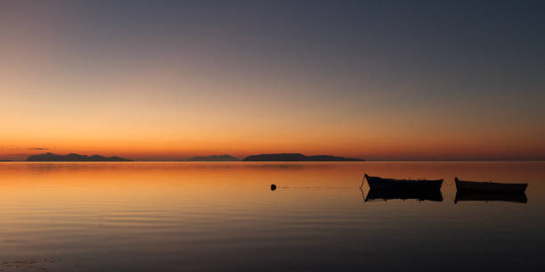istock A warm sunset on a calm water 675680020