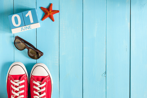 June 1st. Image of june 1 wooden color calendar on blue background.  First summer day. Empty space for text. Happy Childrens Day.