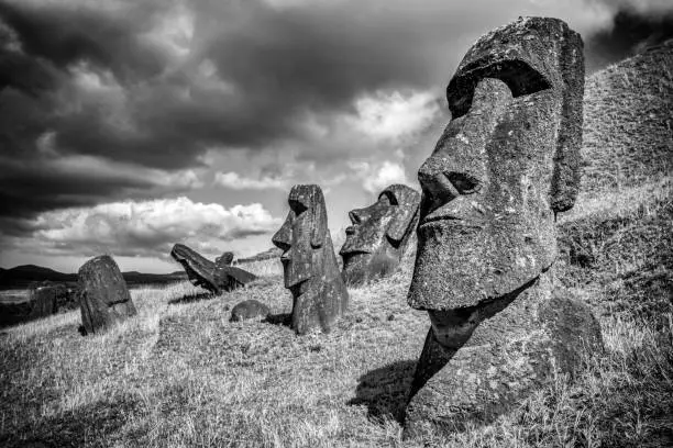 Rano Raraku Easter Island Moai Statues under dramatic skyscape. Black and White. Rano Raraku, Rapa Nui National Park, Hanga Roa, Easter Island, Isla de Pascua, Chile