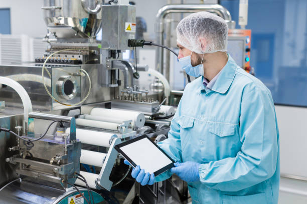 istock scientist near steel machine hold empty tablet 675683664