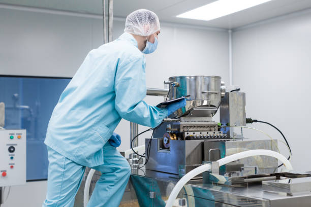 istock plant picture, factory worker making notes about machine 675683720