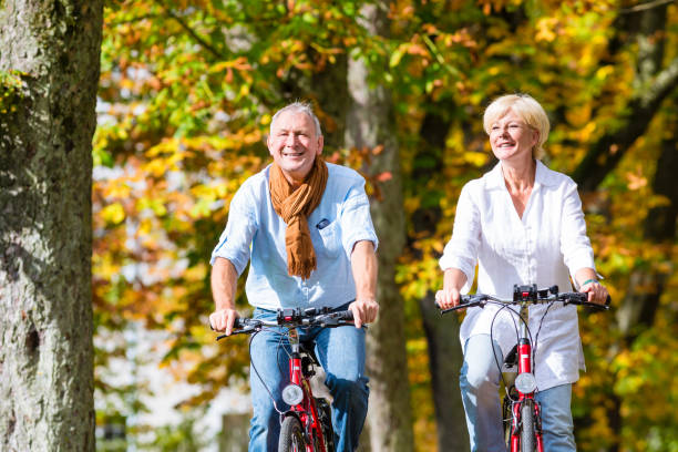 istock Seniors on bicycles having tour in park 675685188