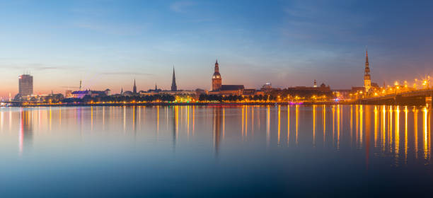 istock Old Riga night skyline. Illuminated city after sunset. Panoramic view over Daugava river 675685560