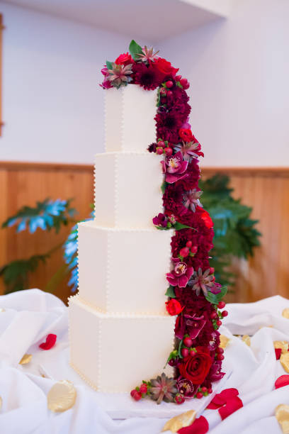 istock Tower Wedding Cake with Red Flowers 675688080