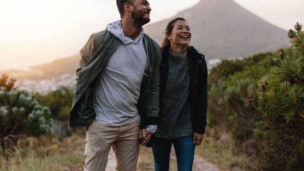 istock Smiling couple walk through country trail 675691390