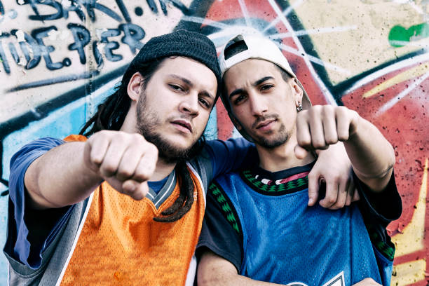 istock two rap singers in a subway with graffiti in the background 675695348