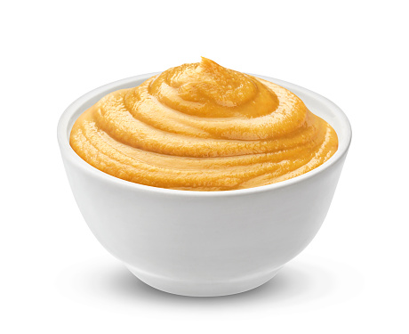 Mustard in bowl isolated on white background with clipping path, one of the collection of various sauces
