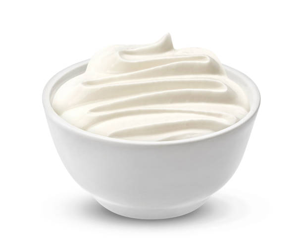 Sour cream in bowl isolated on white background
