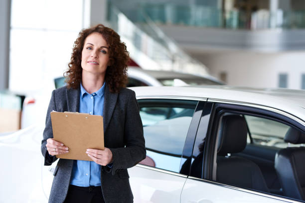 istock Woman as auto dealership worker 675700920