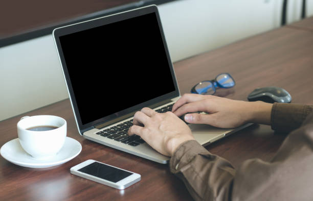 istock Businessman using laptop working in office with cell phone. 675704672