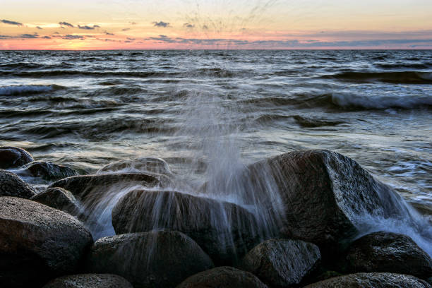 istock The ninth wave. Baltic Sea rocky beach at sunset. 675705244