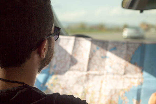 istock The traveling man is looking at the map 675710872