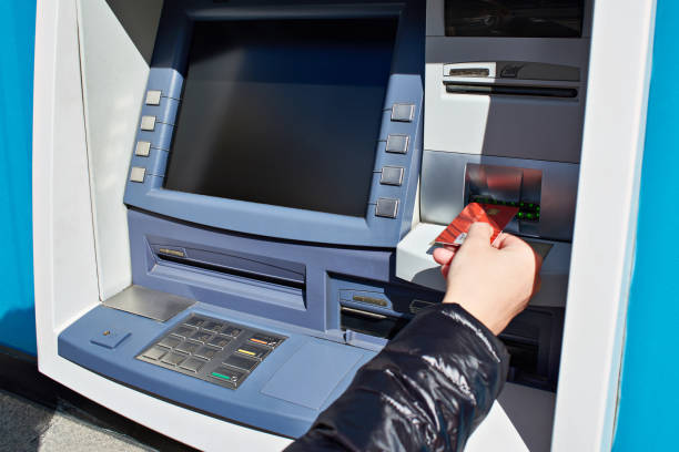 istock Hand with bank card at ATM 675712752
