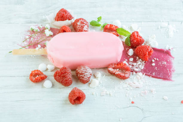 istock raspberries with ice cream in pink chocolate 675716022