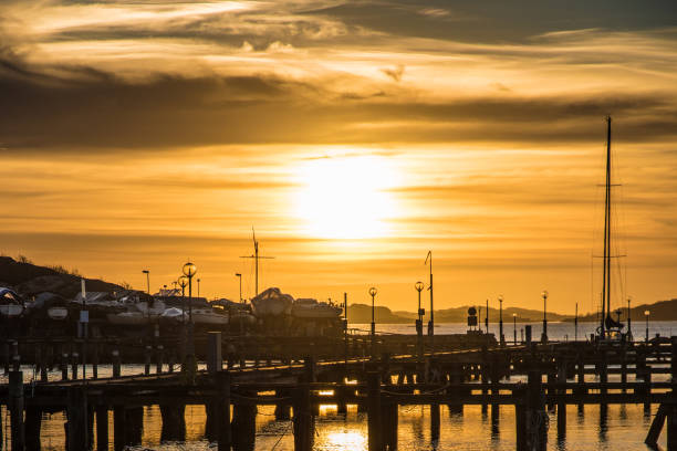 istock Orange and yellow sky above harbor sunset boats 675719690