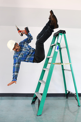 Worker falling off a ladder inside building
