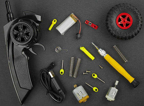 Various parts for radio-controlled models on a dark background top view