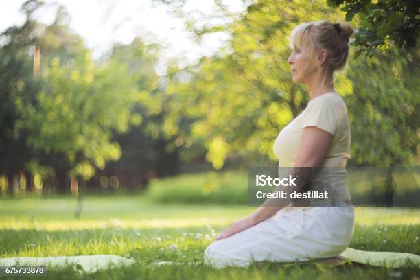 Yoga Woman In Park Stock Photo - Download Image Now - Good Posture, Grass, Senior Women