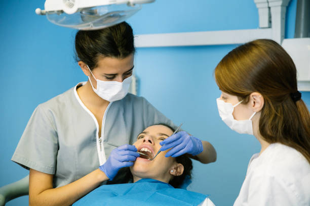 istock Dentists with a patient during a dental intervention. 675736660