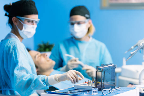 istock Dentists with a patient during a dental intervention. 675743400