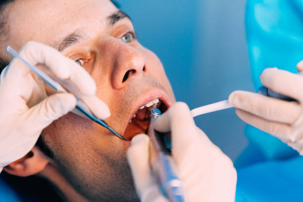 istock Dentists with a patient during a dental intervention. 675743474