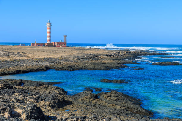 lighthouse building on coast of fuerteventura island on punta de toston near el cotillo town, canary islands, spain - el cotillo imagens e fotografias de stock