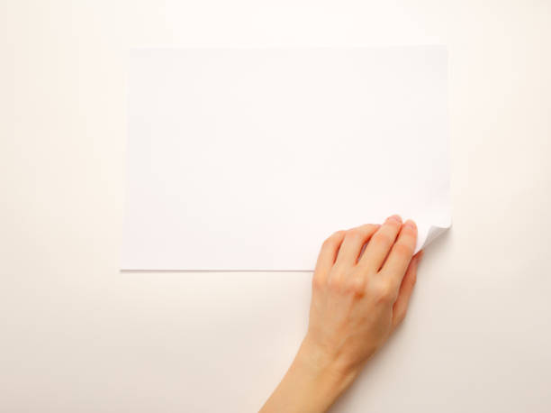 istock Woman's hand turning over paper 675750118