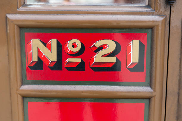 istock Old Railway carriage door with number 21 painted red/gold 675761104