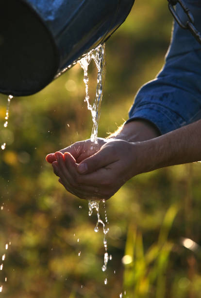 istock man washes hands with transparent water 675767702