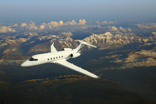 istock Business jet airplane flying over mountains. 675770270