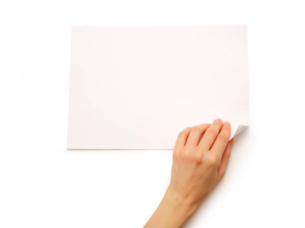 istock Woman's hand turning over paper 675770968