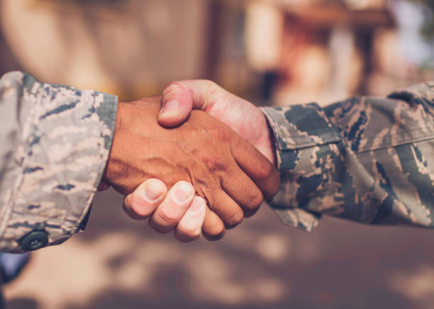 istock Male military soldiers shaking hands 675773746