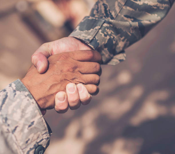 istock Male military soldiers shaking hands 675773764