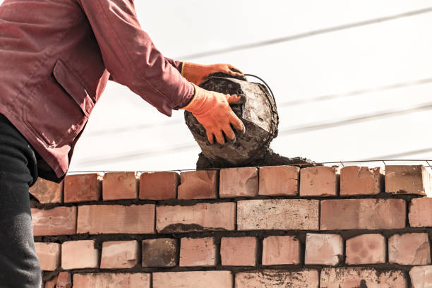 istock Worker builds a brick wall in the house 675779990