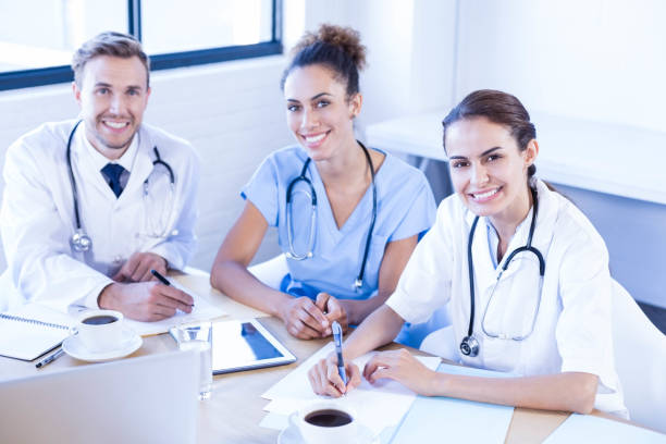 istock Medical team smiling at conference room 675780476